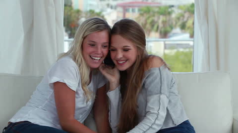 Close Friends Sharing Happy Moments on Cellphone