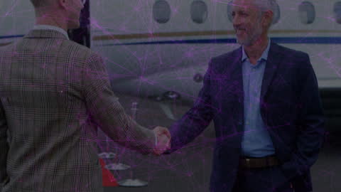 Businessmen Handshaking by Jet with Digital Network Overlay