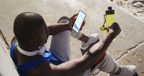 Sporty African American Man Analyzing Fitness Data Outdoors - Download Free Stock Images Pikwizard.com