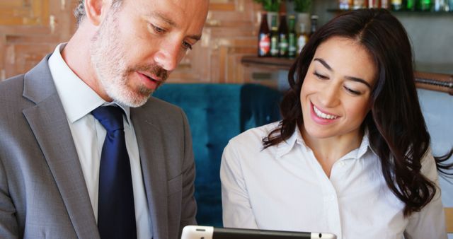 Business professionals using tablet in modern office lounge - Download Free Stock Images Pikwizard.com