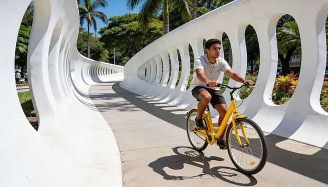 Urban cyclist pedaling yellow bike through curving white sculpture with strong shadows