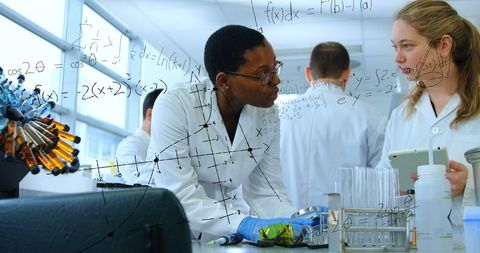 Diverse Scientists Discussing Research in Lab Superimposed with Formulas