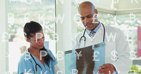 Medical team reviewing x-ray film for diagnostic collaboration in modern clinic