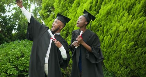 Joyful graduates celebrating milestone outdoors