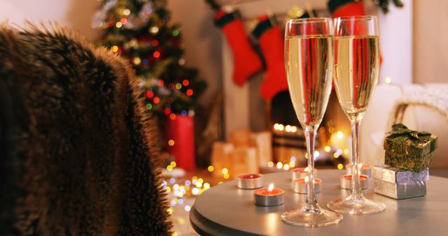 Champagne glasses and gifts box on table in living room 4k
