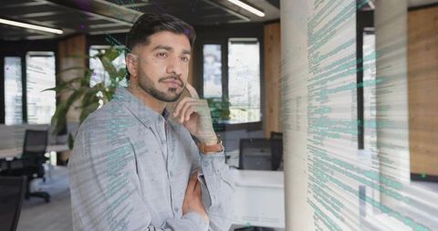 Pensive Professional in High-Tech Workspace Environment