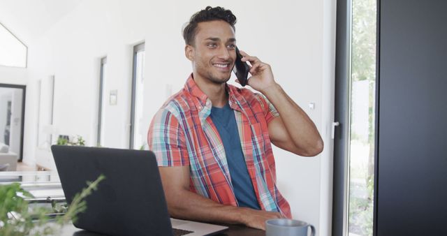 Smiling Man Working from Home Office while Talking on Phone - Download Free Stock Images Pikwizard.com