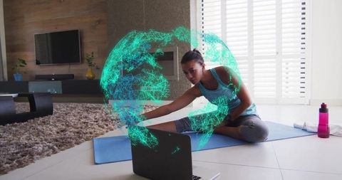 Woman Stretching on Yoga Mat with Holographic Globe on Laptop