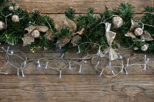 Christmas Garland with Ornaments and Lights on Wooden Background - Download Free Stock Photos Pikwizard.com