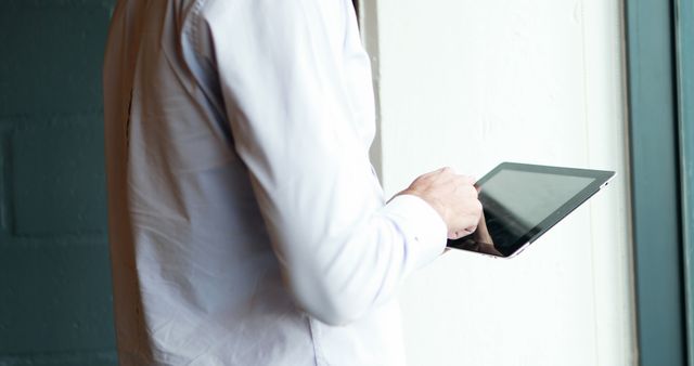 Businessman using digital tablet by window in office - Download Free Stock Images Pikwizard.com