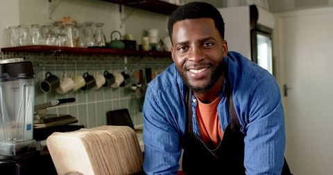Friendly Barista in Cozy Cafe Leaning on Counter