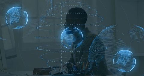 Typing man working with holographic globe data overlays, futuristic network visuals