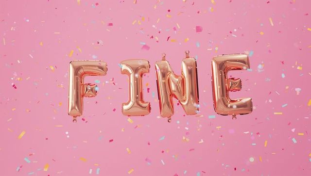 Rose gold foil balloon letters spelling fine with confetti on pink background glossy decor
