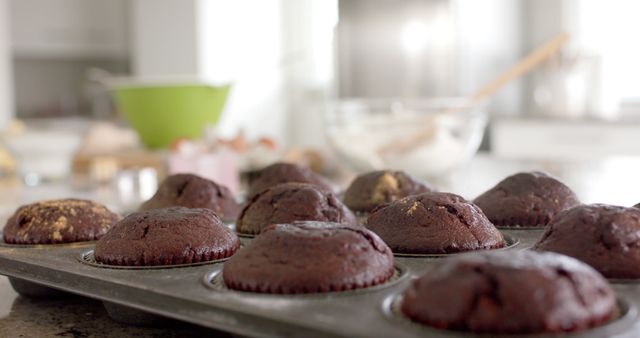 Close up of muffins on worktop in sunny kitchen. Lifestyle, food, cooking and domestic life, unaltered.