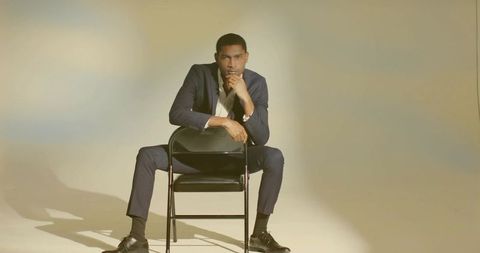 Confident man in navy suit shedding elegance and sophistication