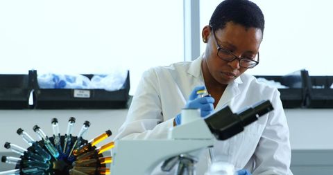 Female Scientist Conducting Laboratory Experiments with Microscope - Download Free Stock Images Pikwizard.com