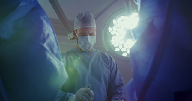 Surgeon in Operating Room Performing Surgery Under Surgical Lights - Download Free Stock Images Pikwizard.com