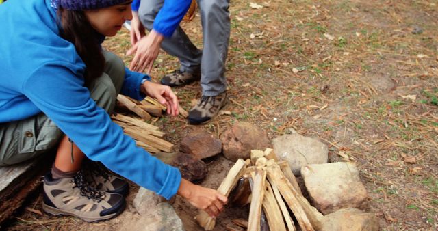 People Preparing Campfire in Outdoor Setting - Download Free Stock Images Pikwizard.com