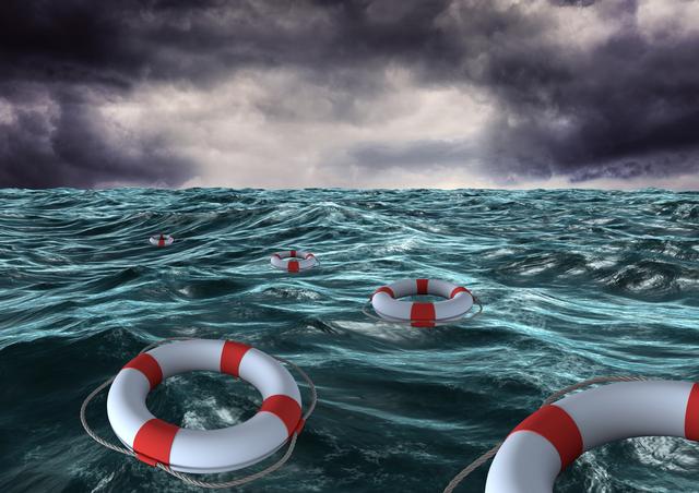 Lifebuoys floating on rough sea surface under a dark, stormy sky presents a dramatic visual of maritime danger and rescue. Suitable for illustrating themes of survival, emergency preparedness, and ocean safety in editorial content, blog posts, disaster simulations, or theatrical posters.
