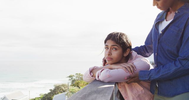 Teen Leaning on Railing Looking Thoughtful While Parent Comforts - Download Free Stock Images Pikwizard.com