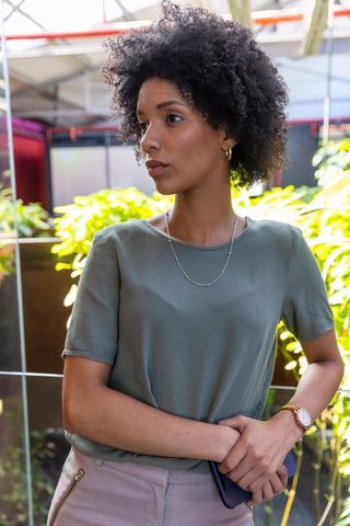 Fashionable woman in urban atrium with smartphone
