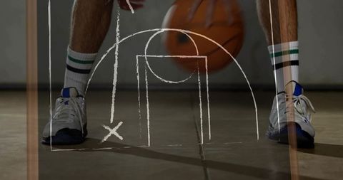 Athlete Dribbling Basketball with Chalk Strategy on Sports Court