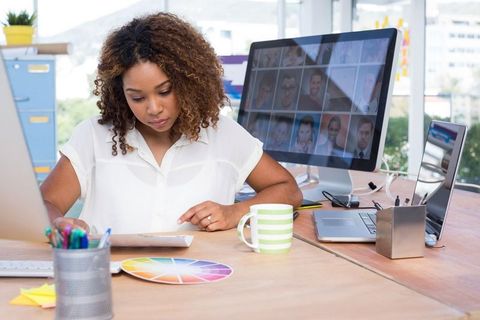 Design Professional Reviewing Color Wheel in Modern Office