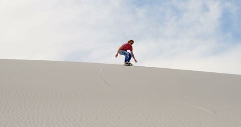 Man Sandboarding Down Vast Desert Dune - Download Free Stock Images Pikwizard.com