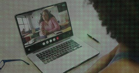 Virtual classroom tutor leading online lesson on laptop screen with student at desk