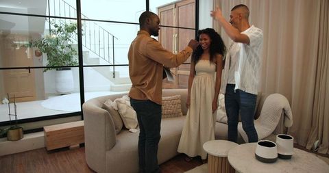 Friends Joyfully Greeting in Modern Cozy Living Room