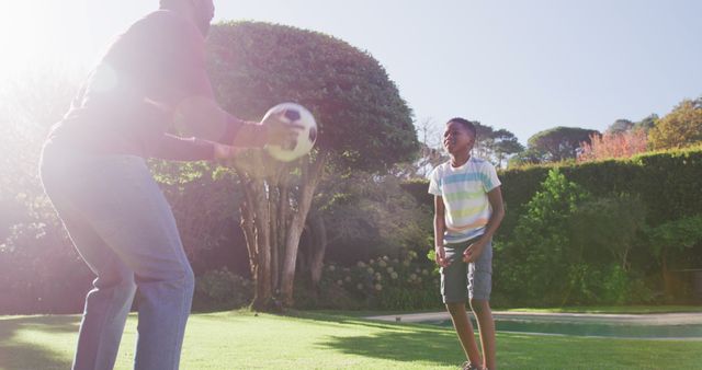 Father and Son Playing Football in Sunny Garden - Download Free Stock Images Pikwizard.com