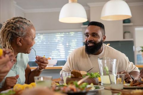 African American Family Gathering Over Meal in Modern Kitchen