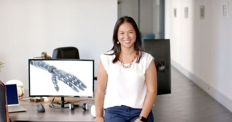 Confident professional embracing robotics in modern office