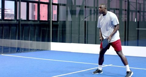 Focused Athlete Playing Padel at Indoor Sports Facility