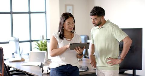 Team collaboration using tablet in modern office environment