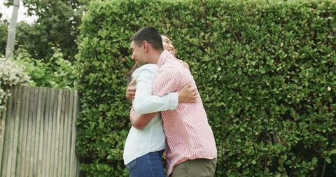 Joyful embrace between friends in indoor picnic setting