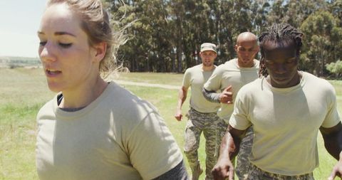 Soldiers running through army obstacle course