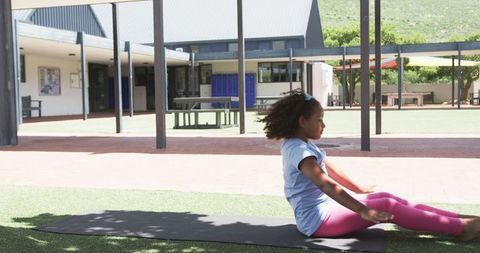 Young Girl Performing Outdoor Yoga in Schoolyard