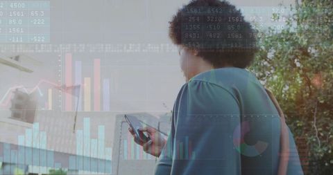 Woman Holding Smartphone with Financial Charts Overlay in Urban Environment