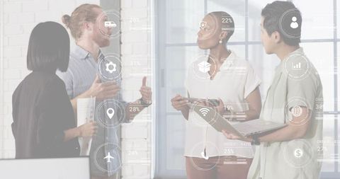 Diverse team collaborating with laptop and tablet showing digital analytics hud overlays
