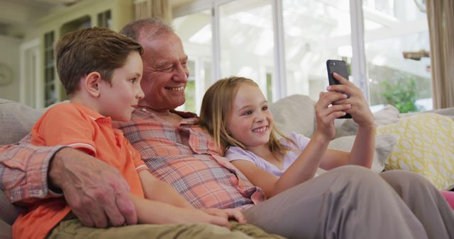 Grandfather with Grandchildren Watching Video on Smartphone - Download Free Stock Images Pikwizard.com