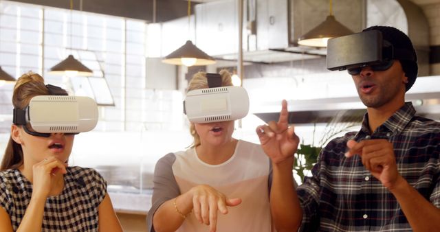 Group of three young adults wearing virtual reality headsets, engaged in an immersive experience in contemporary living room. Ideal for illustrating modern technology usage, interactive gaming, social technology experience, and virtual reality innovation in lifestyle contexts.