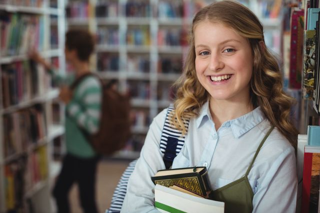 Schoolgirl holding books and smiling in a library. Ideal for educational content, school promotions, academic websites, and youth-oriented materials.