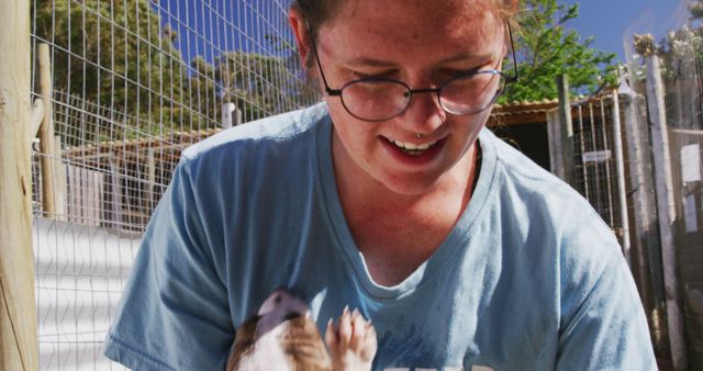 Woman caring for small pet animal outdoors - Download Free Stock Images Pikwizard.com