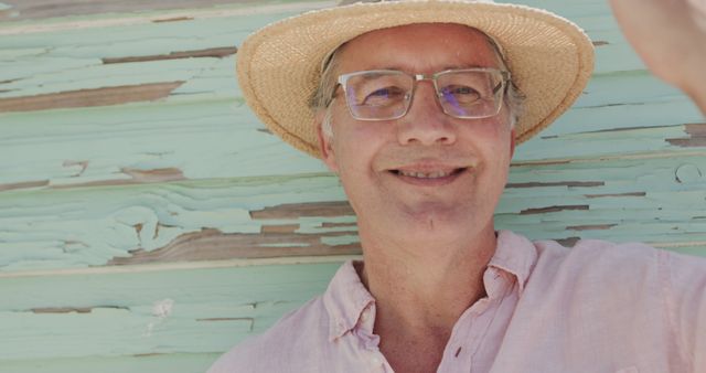 Senior man wearing straw hat smiling outdoors - Download Free Stock Images Pikwizard.com