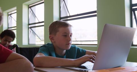 Focused Schoolboy Using Laptop Indoors Classroom Environment - Download Free Stock Images Pikwizard.com