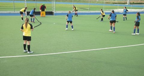 Women field hockey game on artificial turf