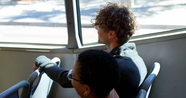 Two People Sitting by Bus Window Enjoying Sunny Day - Download Free Stock Images Pikwizard.com