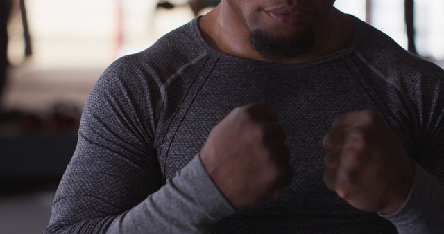 Male Athlete With Raised Fists Wearing Long Sleeved Shirt - Download Free Stock Images Pikwizard.com