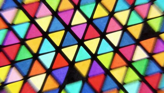 Vibrant Geometric Triangle Mosaic Macro Close-Up with Bold Black Dividers and Saturated Colors